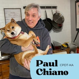 Dog trainer Paul holding dog and smiling